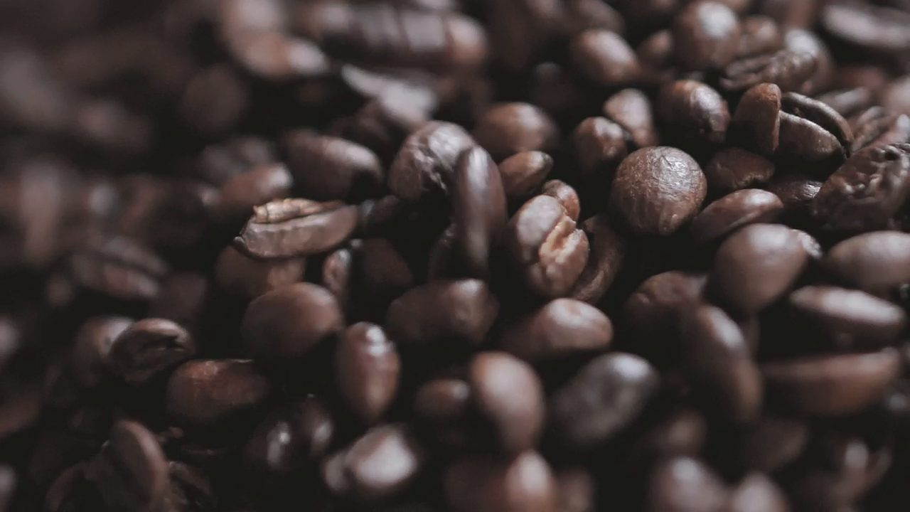 Coffee brewing slowly in warm, low light